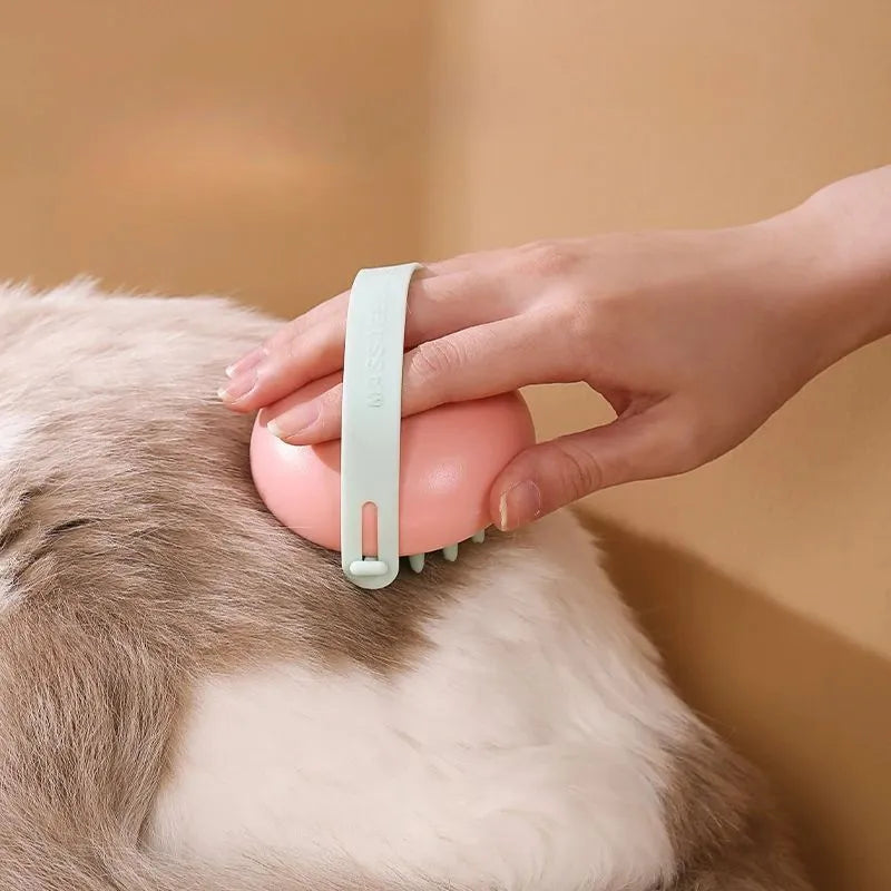 Blue silicone pet bathing and grooming brush with soft bristles and an ergonomic handle.