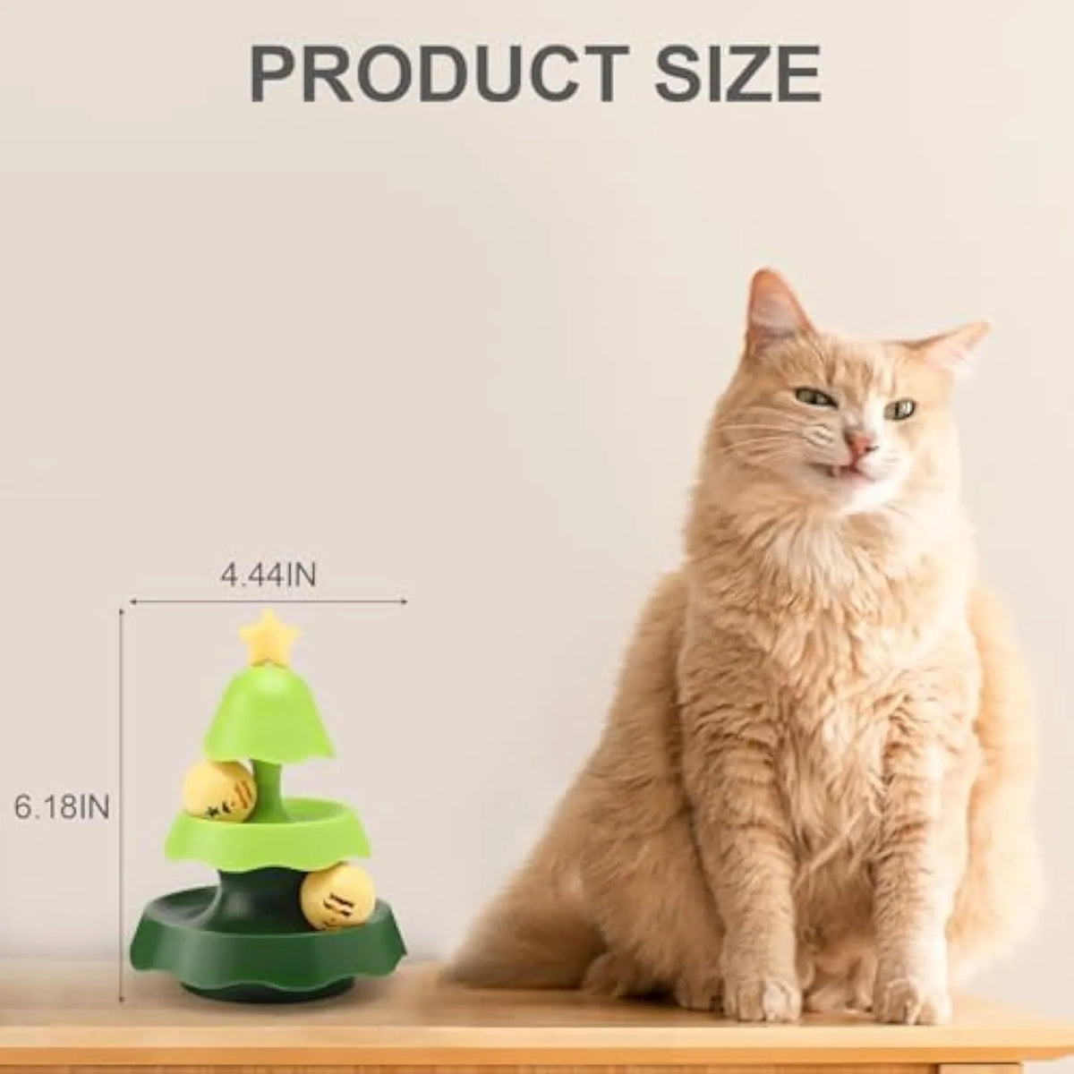 Tree-shaped cat toy track with two tiers of rolling balls and a catnip ball under a green cover on the floor