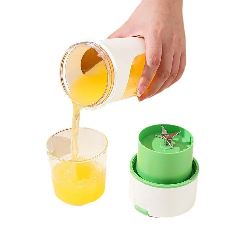 Blue portable electric juicer with USB charging cable next to a cup of blended fruit smoothie.