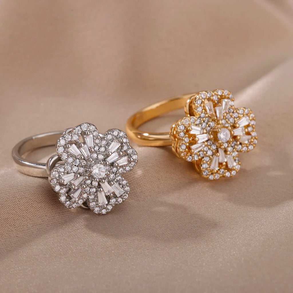 Rotatable flower ring with rhinestones on a woman's finger, available in gold or platinum finish