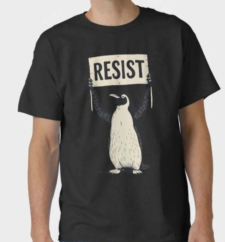 A loose-fitting black short-sleeve cotton t-shirt with a round neck on a hanger.