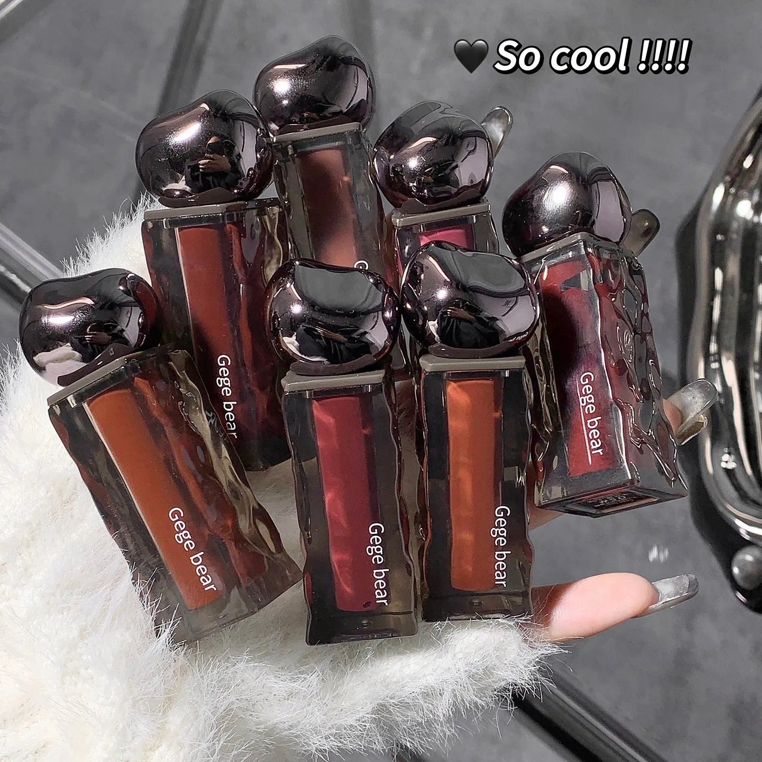 Mirror finish lip lacquer tube with water-light glossy texture in seven numbered colour shades
