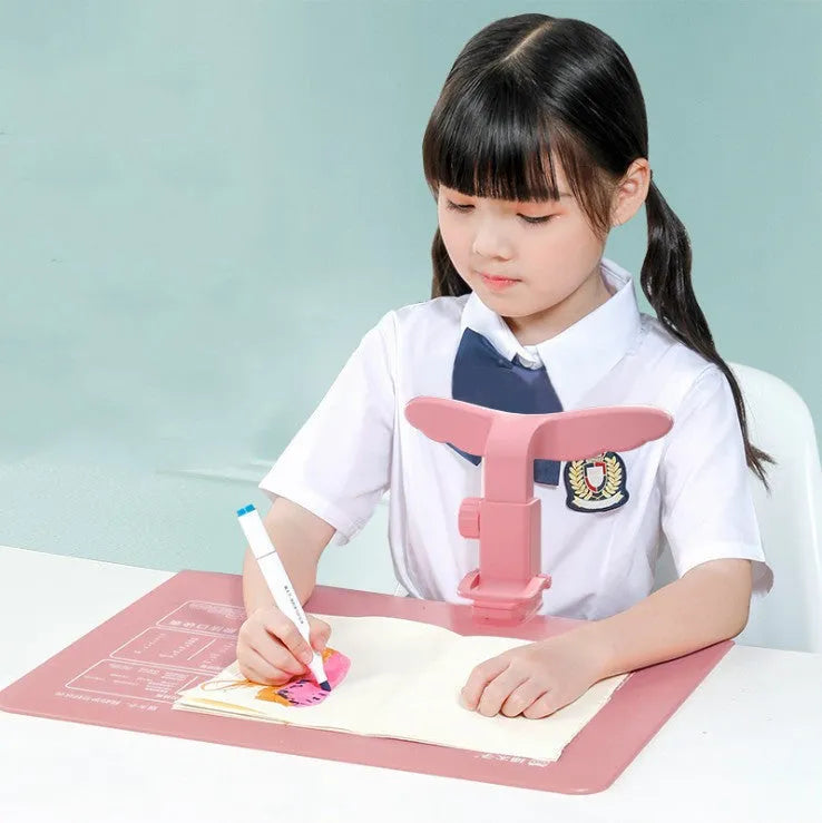 Student anti-myopia seated orthosis in blue on a desk, made from silicone and ABS material