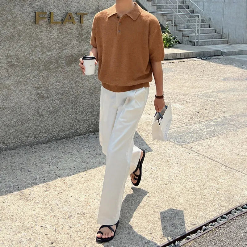 Men's caramel coloured retro knitted polo shirt with short sleeves and an asymmetrical design laid flat.