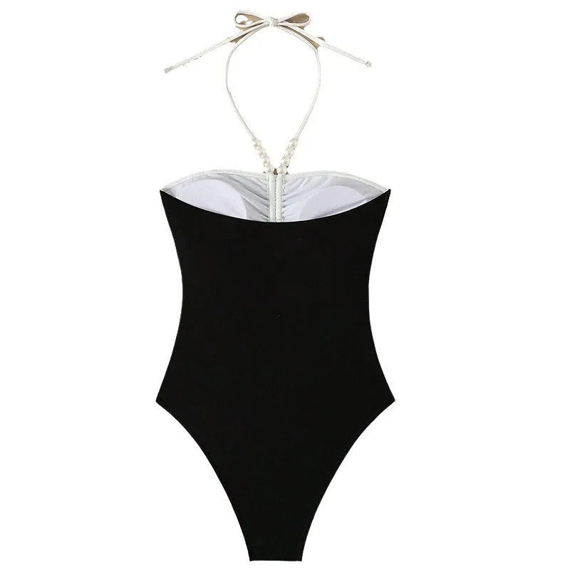 Black and white women's one-piece swimsuit with pearl spaghetti straps, slim fit for swimming.