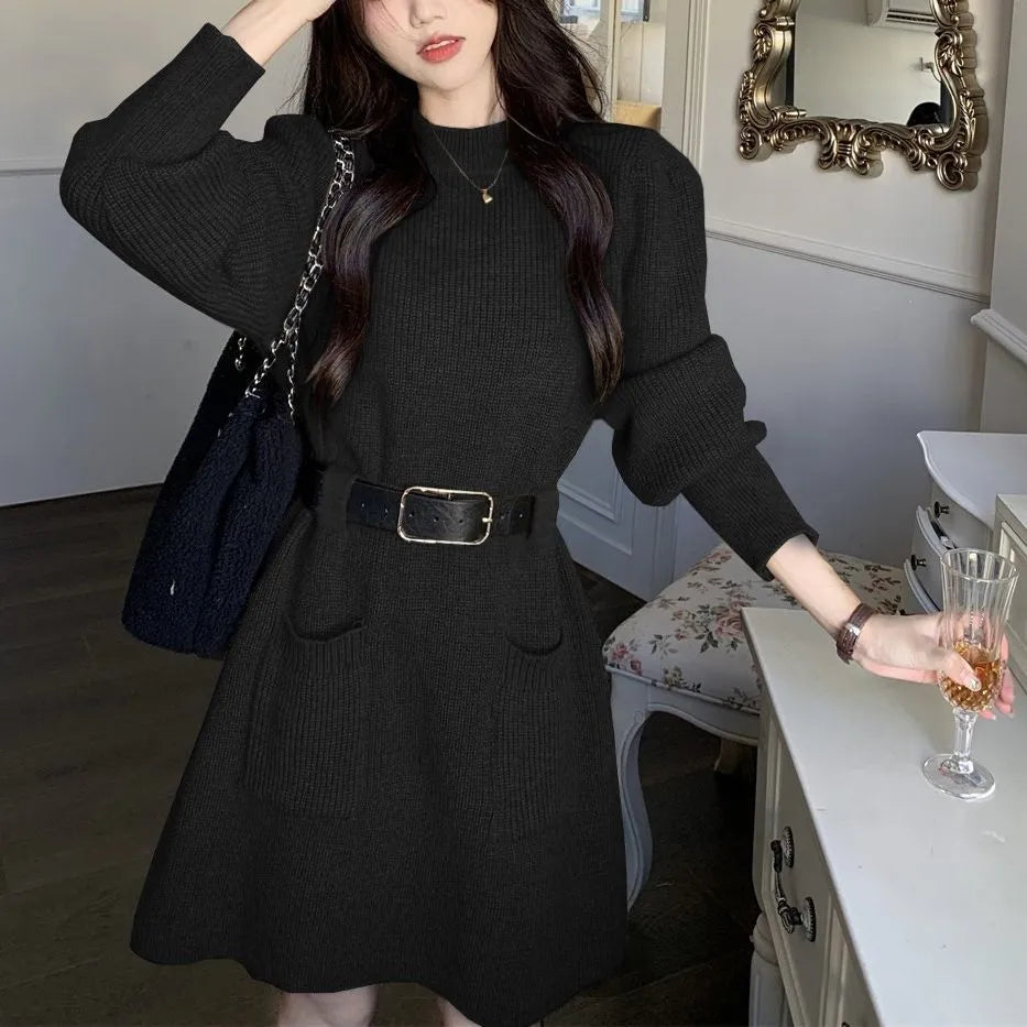 Women's loose knitted dress with long sleeves and high waist, shown in beige with black belt