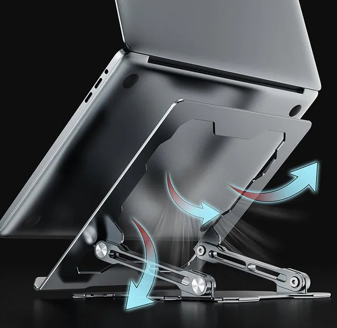 Grey aluminium laptop stand in a folded position next to an open laptop, showing its adjustable angle and hollow design.