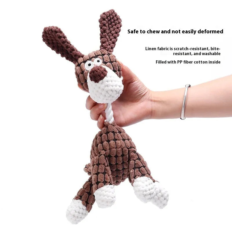 Assorted plush dog toys including a pink-gray donkey, a beige donkey, a blue elephant, and yellow ducks in three sizes.