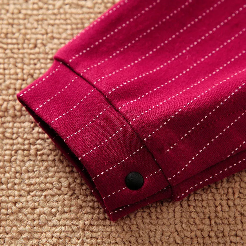 Baby boy wearing a wine red cotton gentleman-style long sleeve jumpsuit with single-breasted closure.