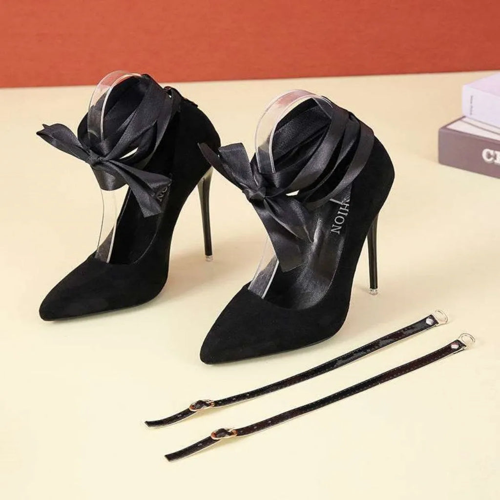 Women's black pointed toe stiletto heels with a thin shallow mouth and lace ankle strap.