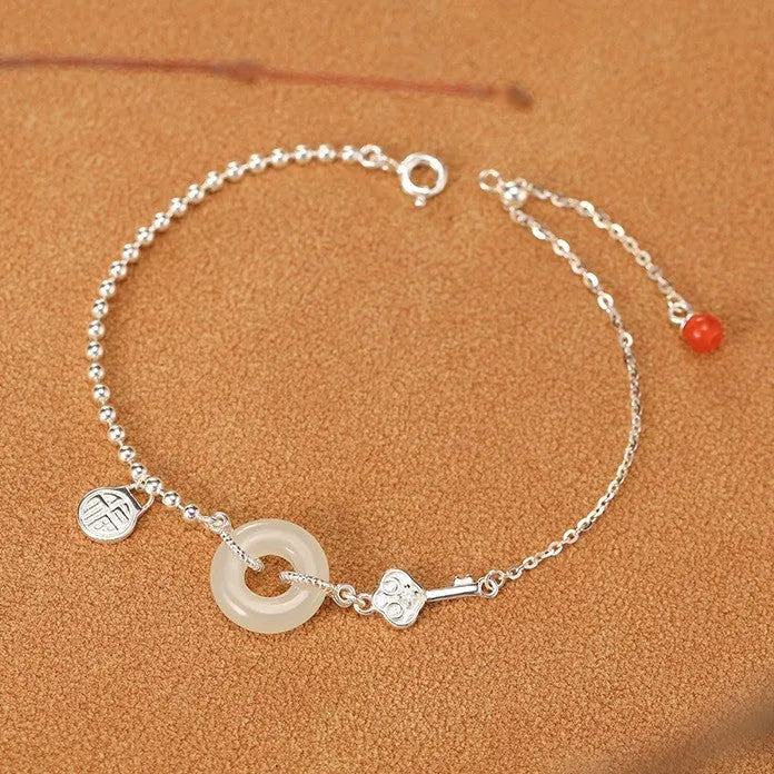 Women's silver bracelet with Hetian jade and geometric peace buckle design in Chinese style