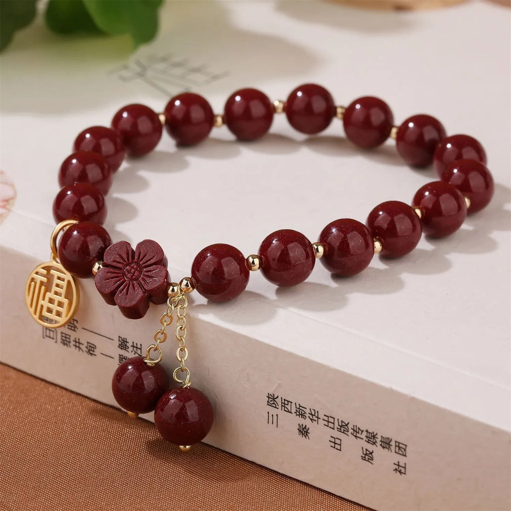 Women's purple gold sand fu character bracelet with peach blossom tassel detailing and handcrafted cinnabar construction