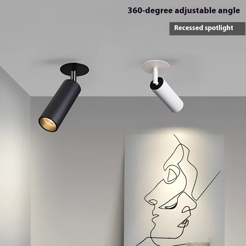 Black recessed cylinder LED spotlight installed in a ceiling track, showing adjustable head.