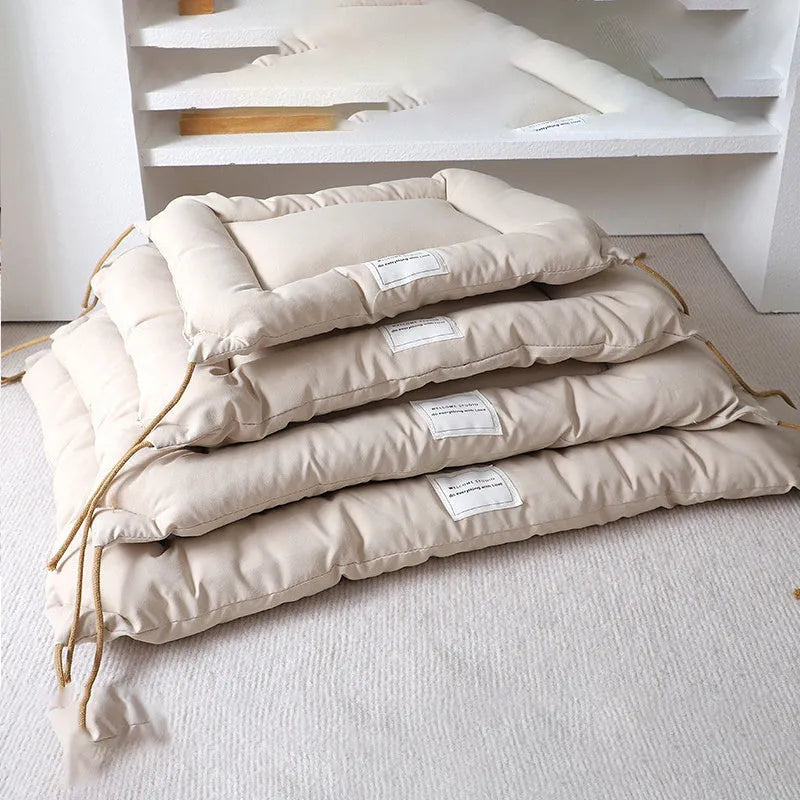 Beige tied cage cushion for small dog in crate showing secure attachment and warm bedding platform.