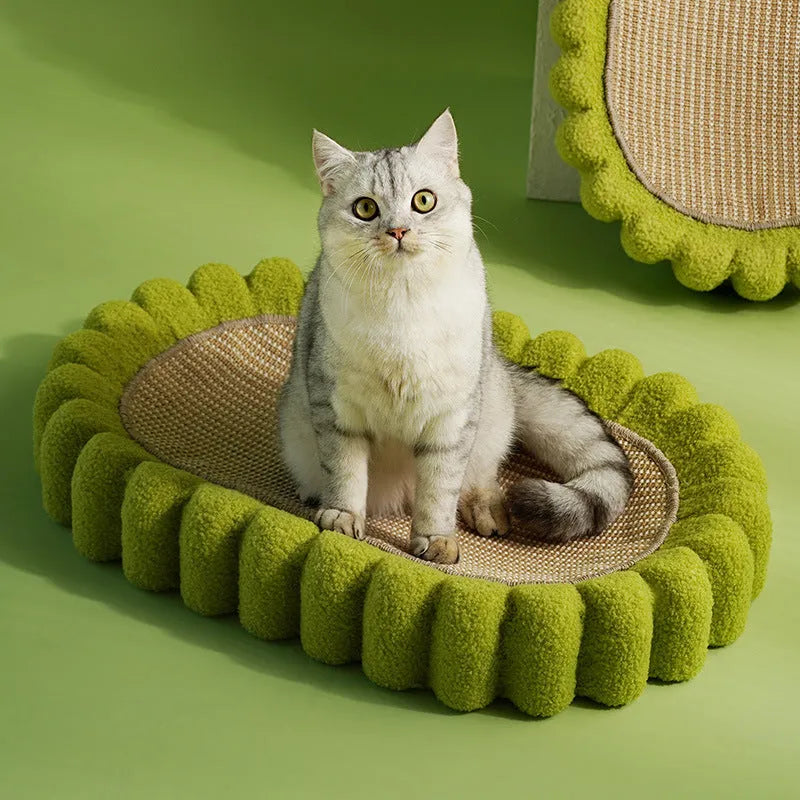 Green oval-shaped cat scratching pad serving as a bed with a sisal surface