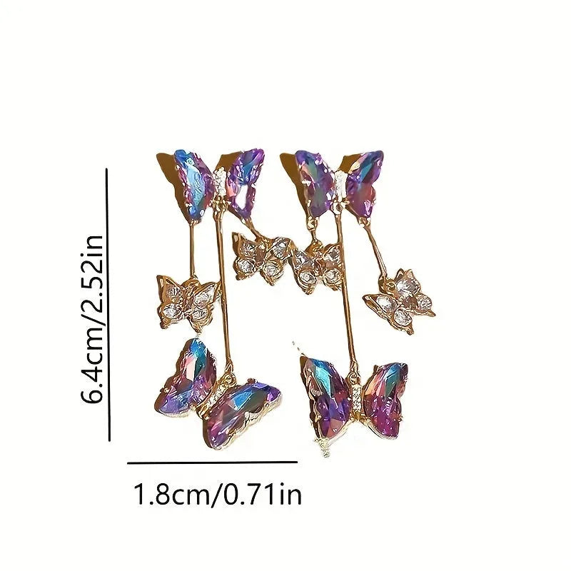 Silver Needle Blue Purple butterfly and crystal flower tassel drop earrings on a white background.