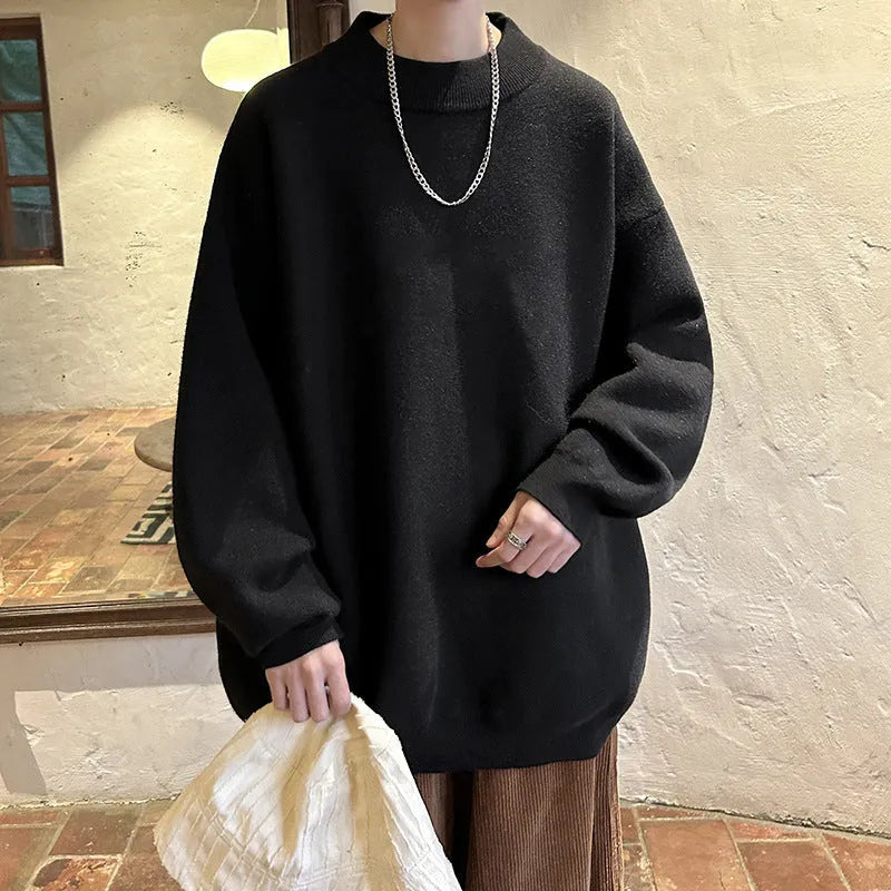 Man wearing a loose grey round neck long sleeve polyester sweater for casual spring or autumn attire.