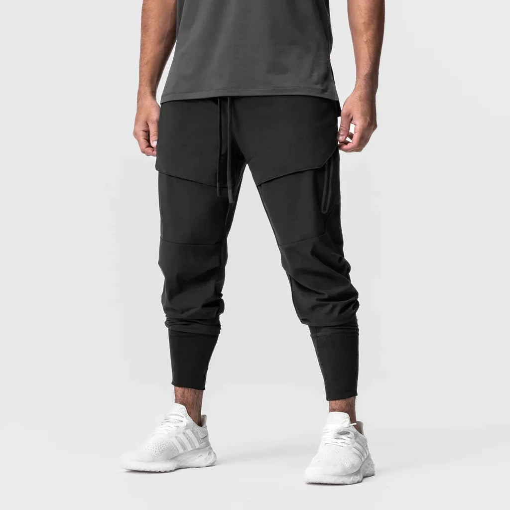 Men's solid colour polyester jogger pants in black, mid-waist micro-elasticity sports trousers for autumn leisure.