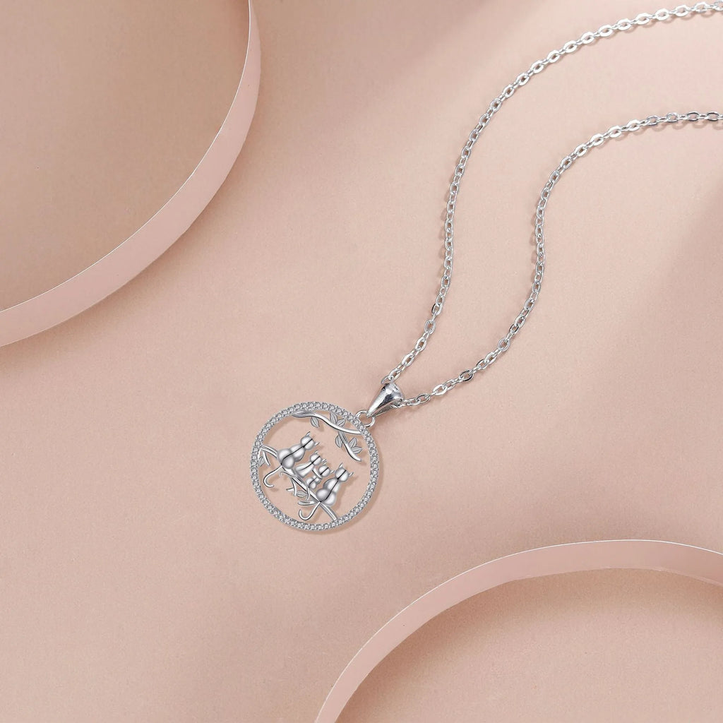 Women's copper necklace with four kitten pendants on cross chain design