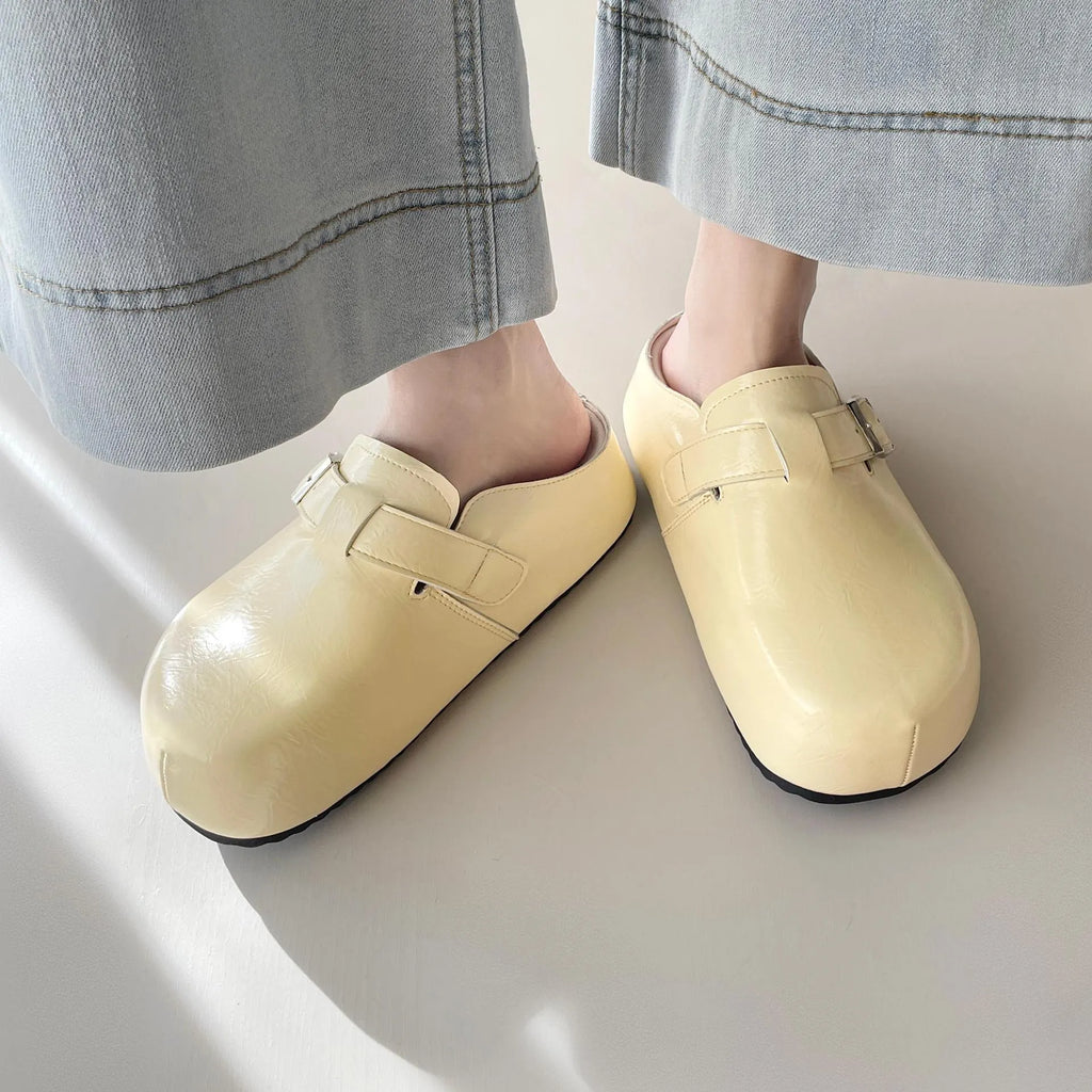 Flat buckle casual slippers with round toe and PU upper in beige colour on a clean surface