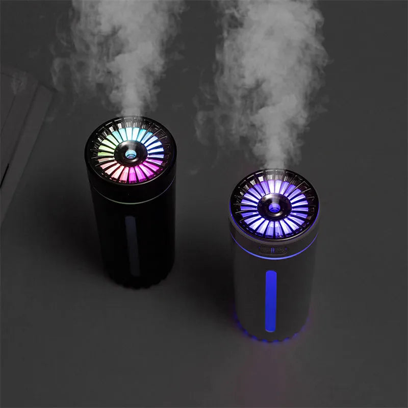 Black wireless portable humidifier with colourful lights beside car cup holder