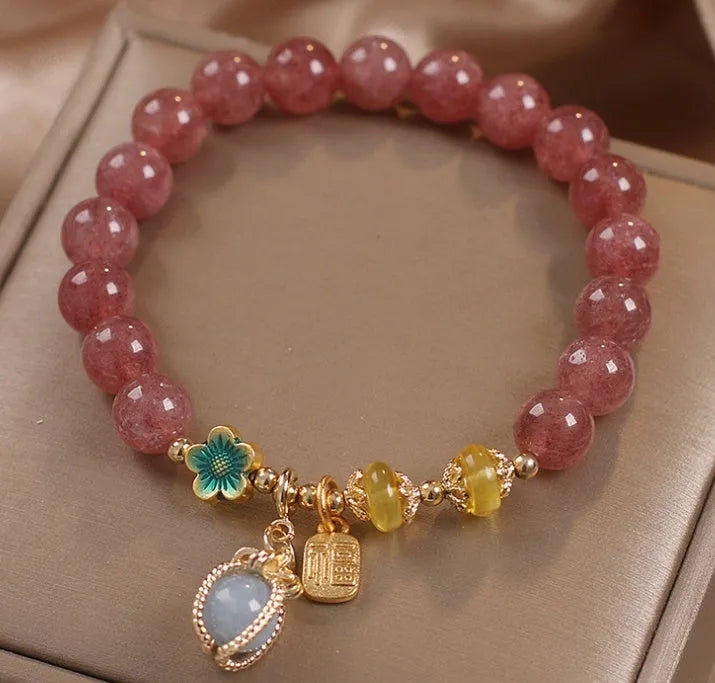 Red women's beaded bracelet with a strawberry quartz centre stone and sparkling rhinestones on an alloy chain.