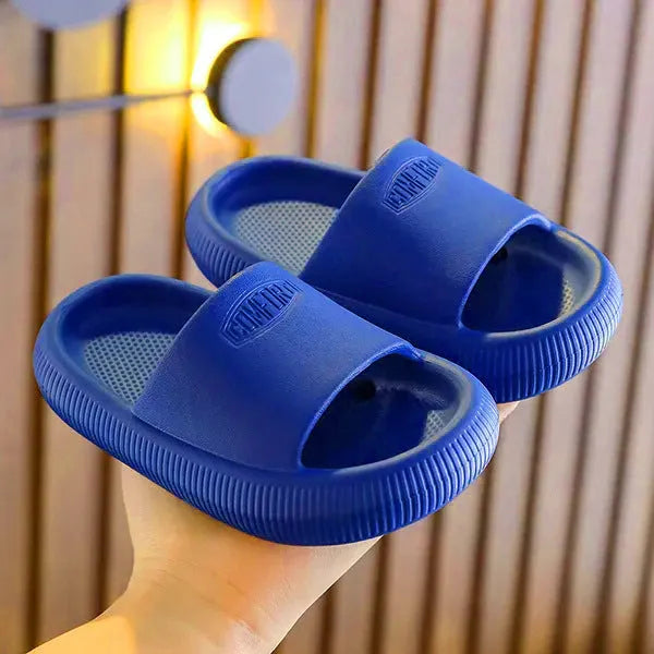 Bright coloured children's EVA slippers with textured sole, shown in blue, green, orange, pink, and yellow.
