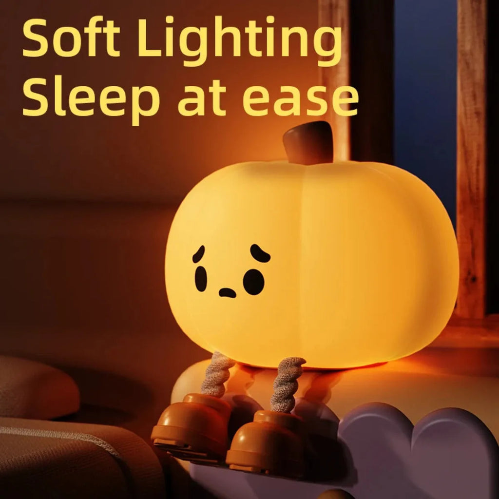 Pumpkin-shaped silicone night light with rechargeable battery on a bedside table