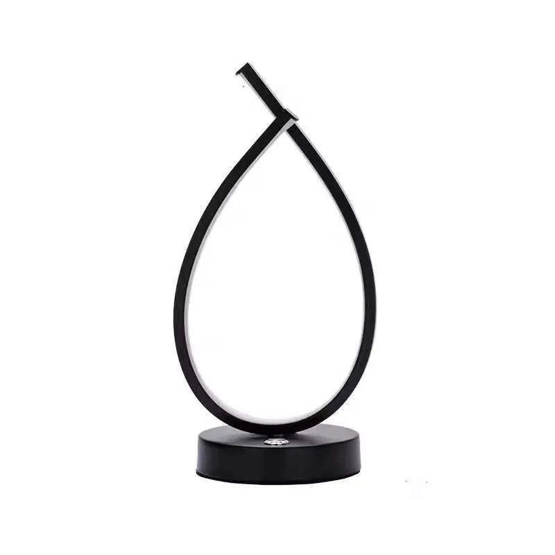 Water drop shaped table lamp in black or white with warm light and USB power
