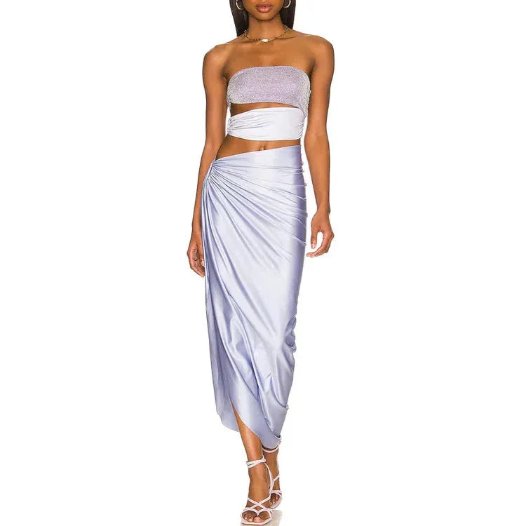 Purple women's one-piece swimsuit with a matching wrap skirt on a model, showing the quick-dry fabric and tight fit.