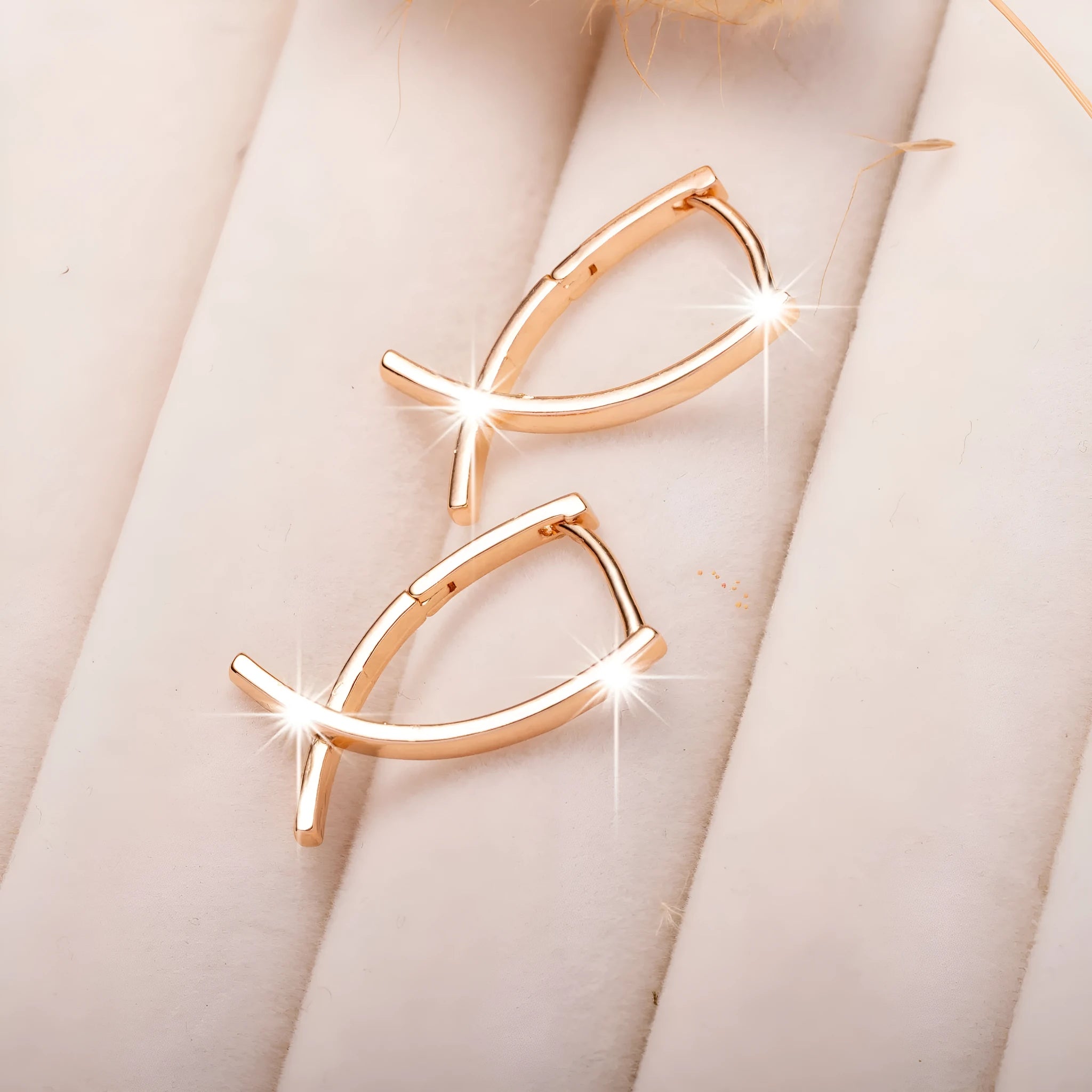 Rose gold cross shaped earrings with a polished finish on a solid copper base.