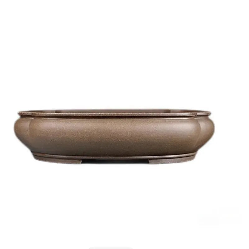 Handmade antique Pukou style papaya-shaped purple clay flower pot on a table.