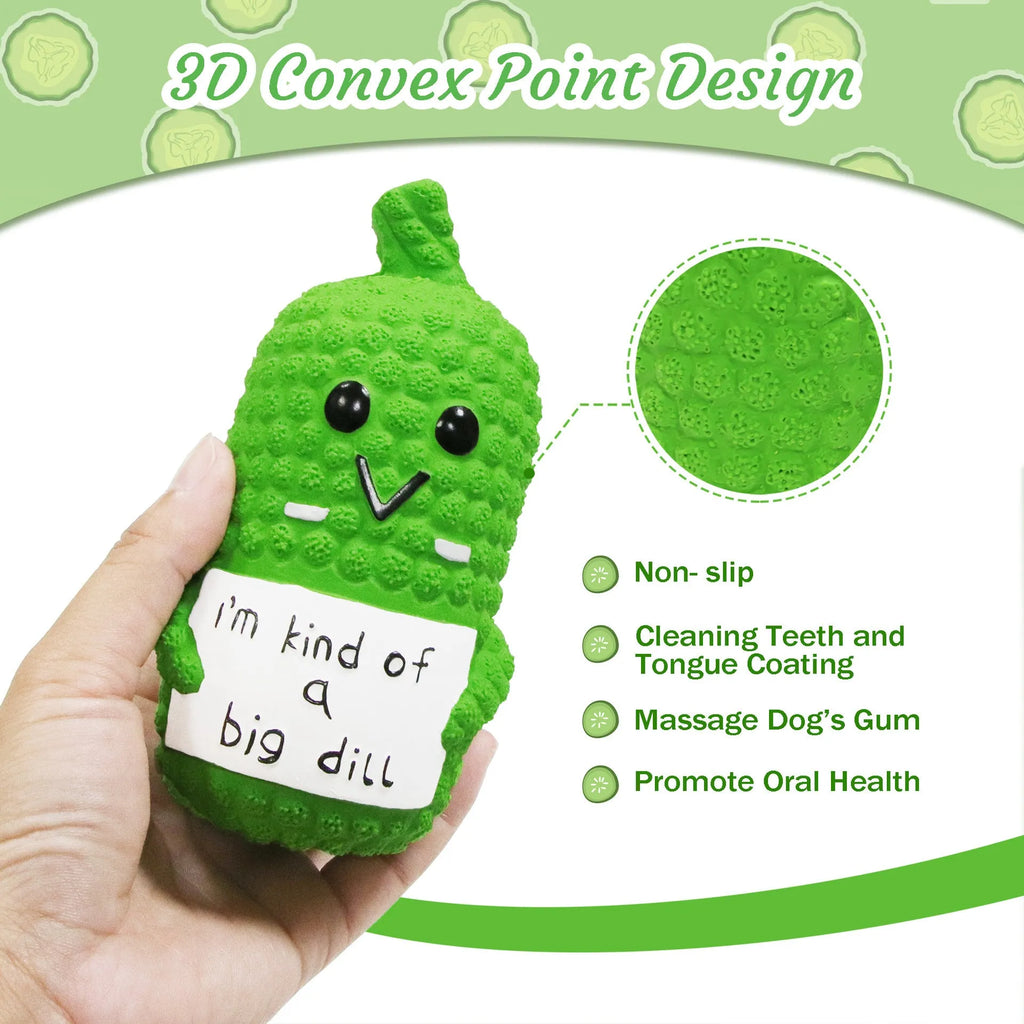 Green pickle-shaped squeaky dog toy with textured nubs, shown next to a measuring tape indicating 13.6 cm length.