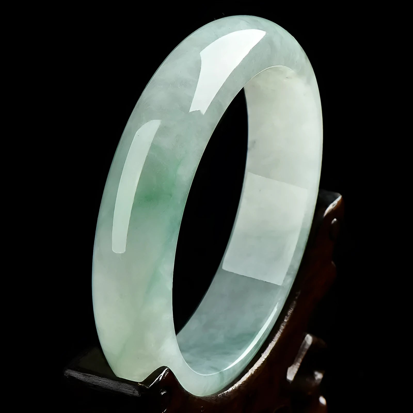 Light green jade bracelet showing natural stone material on wrist