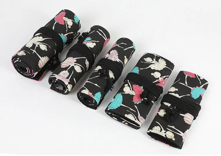 Canvas rolling pencil case with ballet girl print, showing multiple pencils organised in holes.