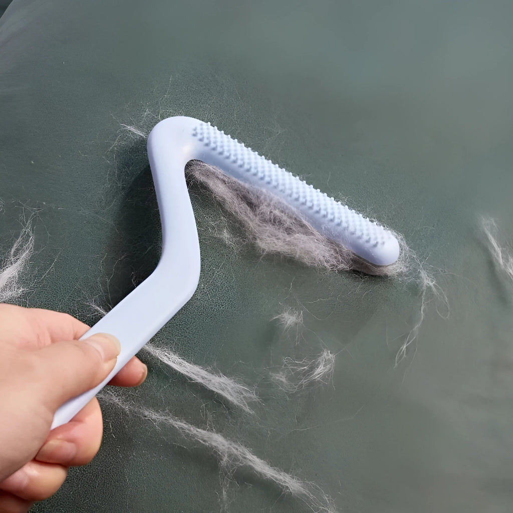 Double-sided pet hair removal comb in blue for removing cat and dog fur from beds and upholstery