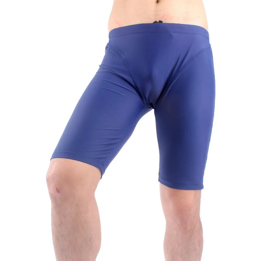 Men's green loose-fit five-point swimming trunks made from quick-drying nylon fabric.