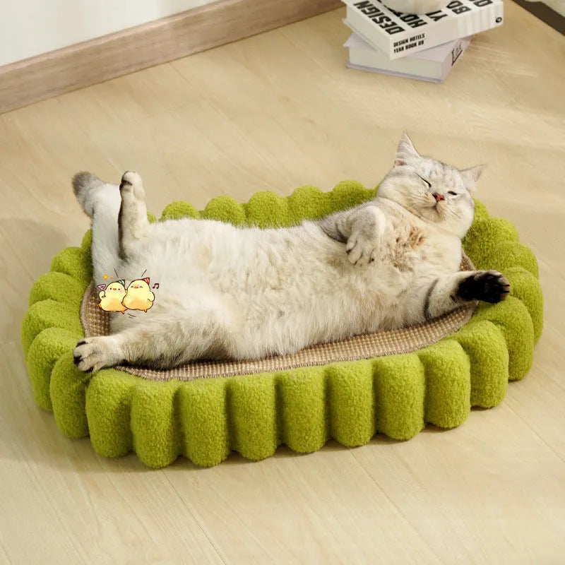 Green oval-shaped cat scratching pad serving as a bed with a sisal surface
