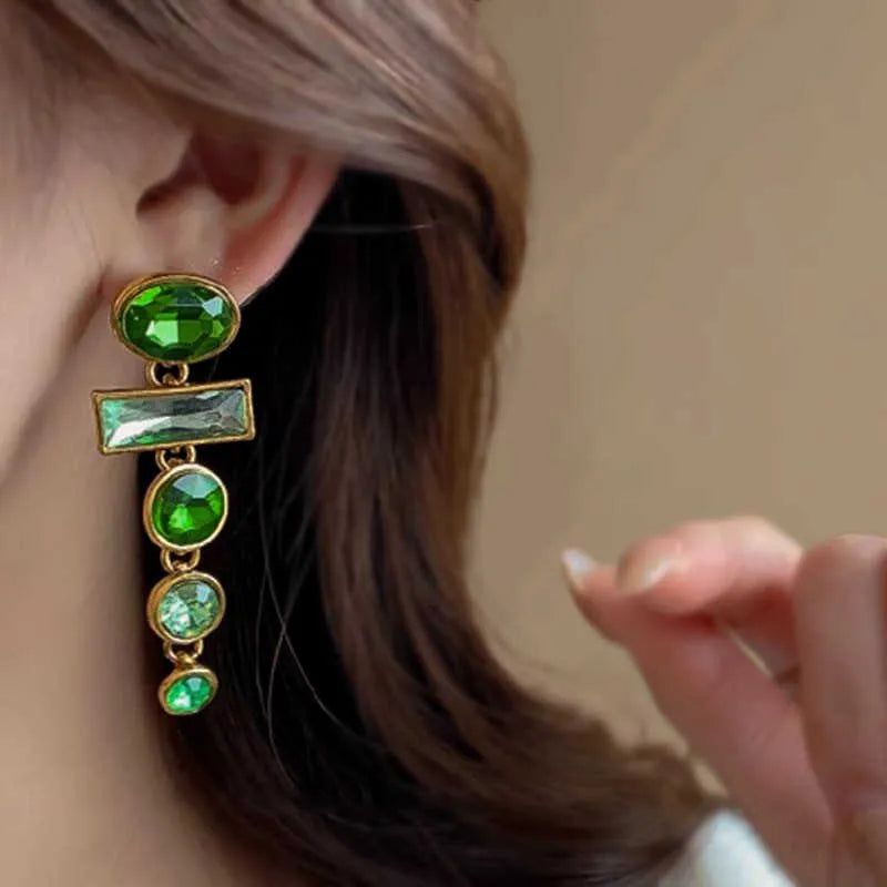 A pair of green gradient geometric alloy stud earrings with inlaid zircon stones and a dangling tassel.