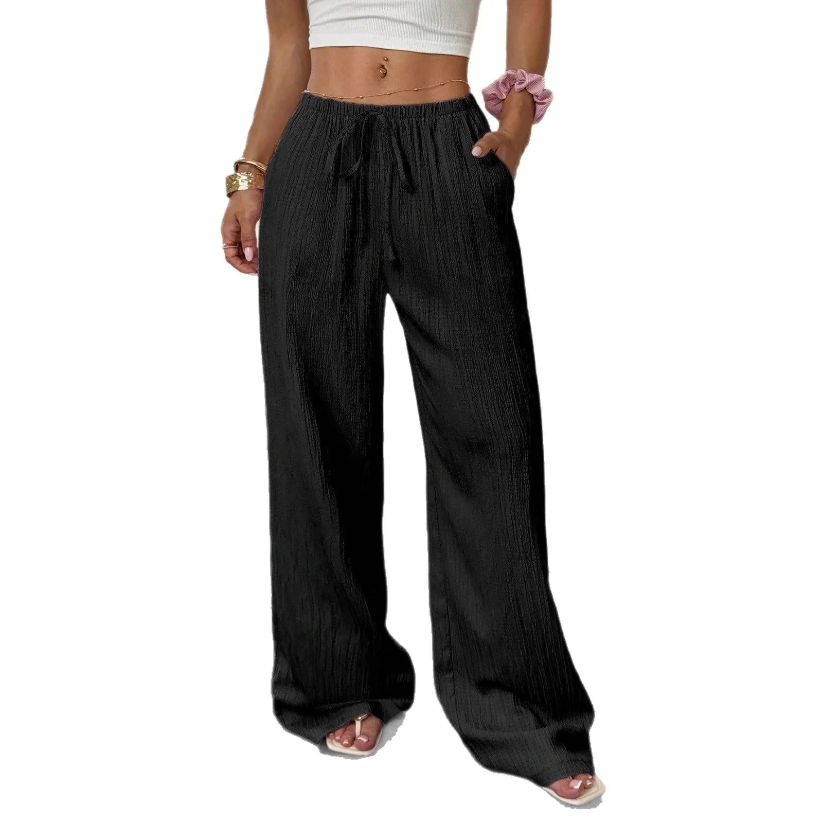 Women's black wide-leg trousers with a front lace-up waist detail, shown in a casual standing pose.