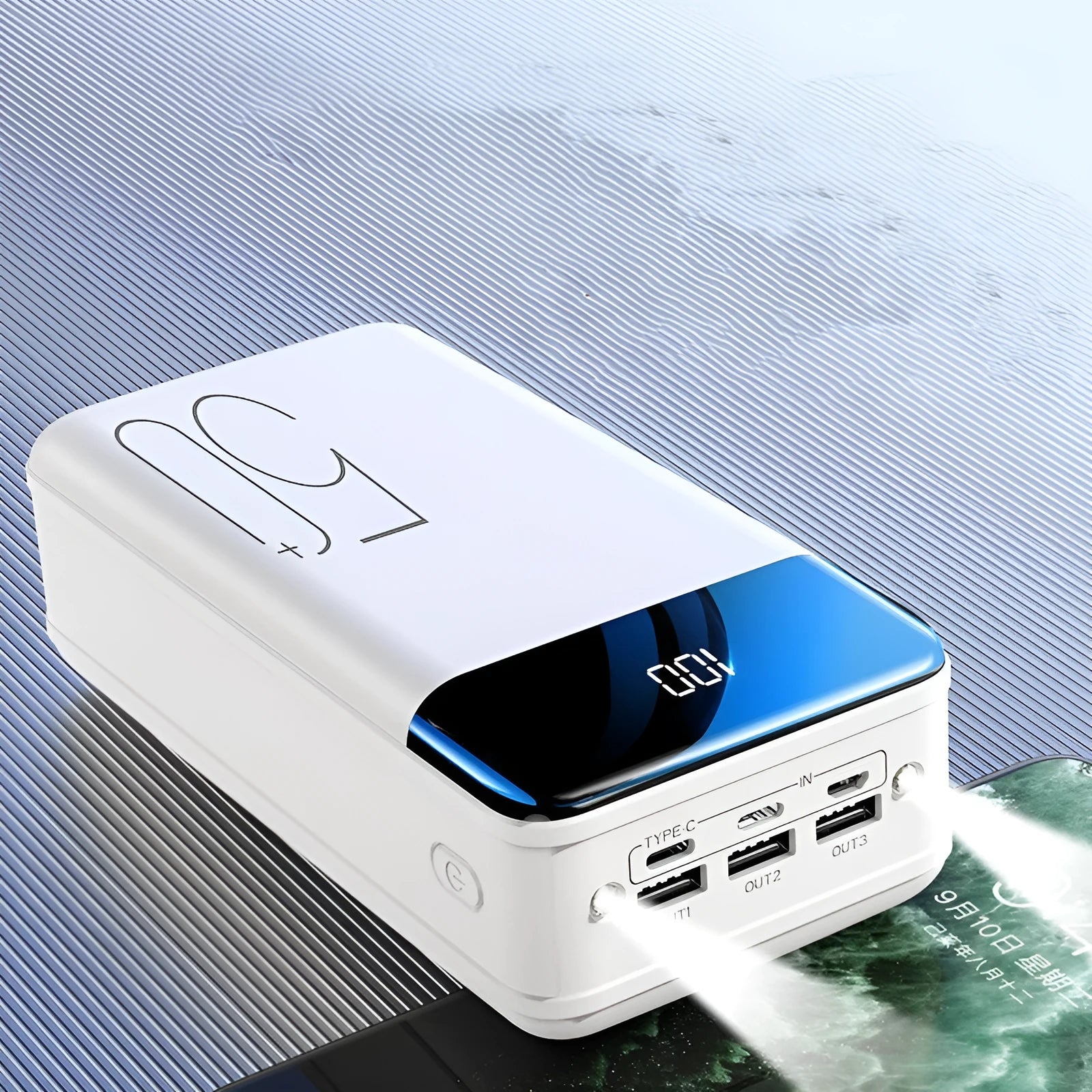 Black and white large 50000mAh power bank with three USB output ports on a plain background.