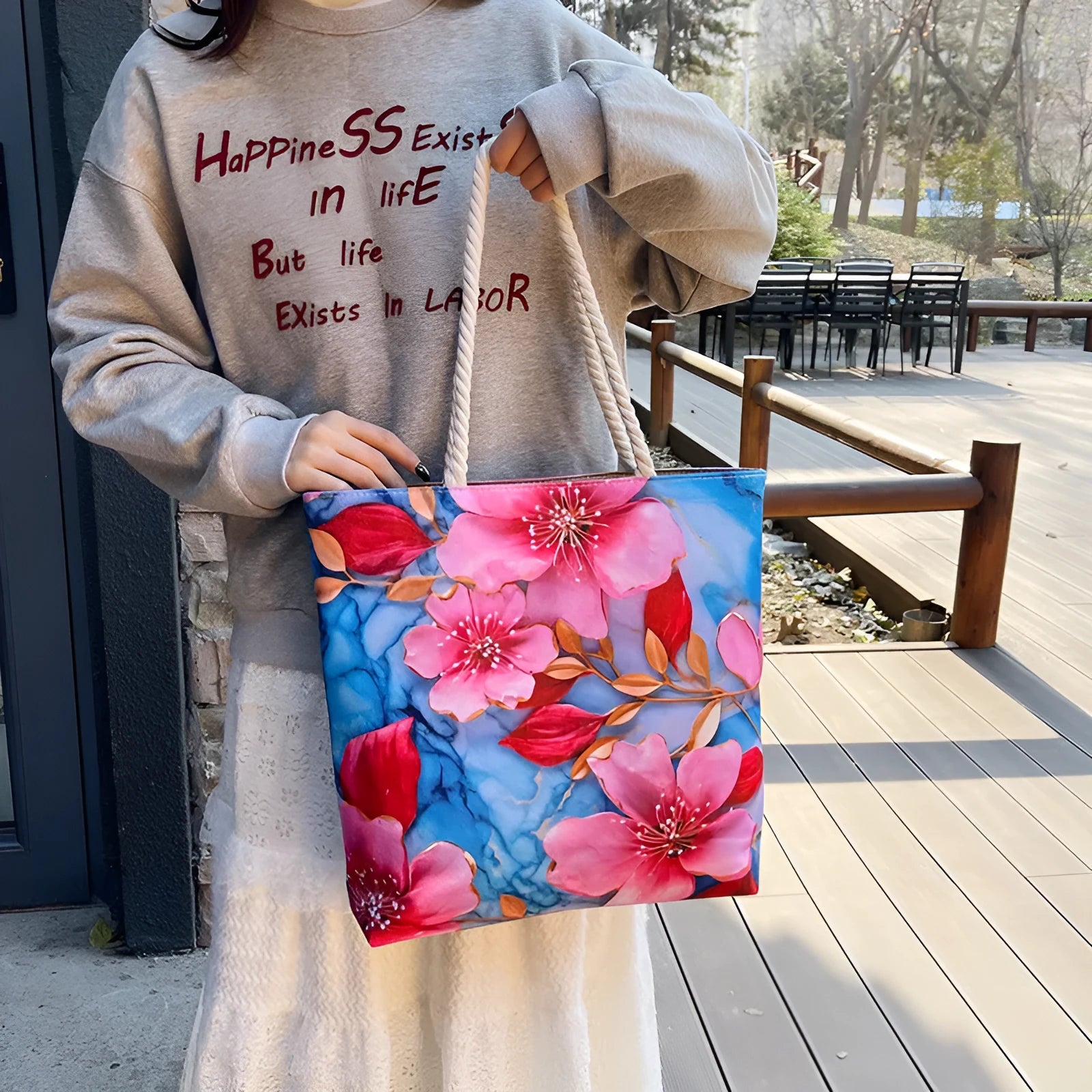 A soft cotton and linen string shoulder handbag with two straps and an open outer pocket.
