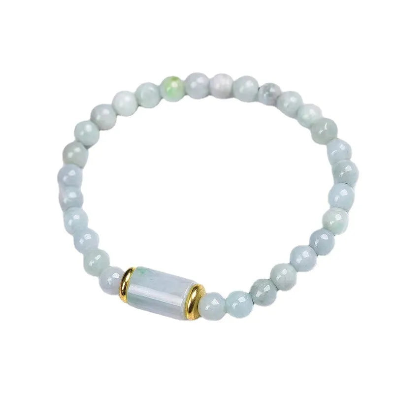 Close-up of a natural emerald green Myanmar jade stone bracelet with round lucky beads on a wrist.