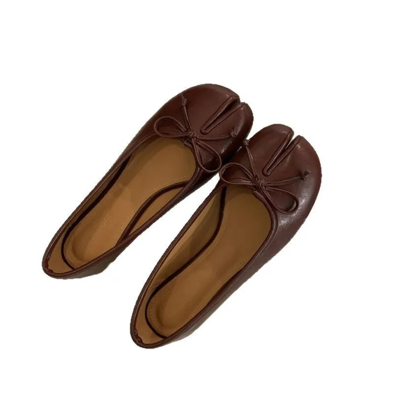 Women's flat split-toe pumps in beige with round toe and rubber sole.