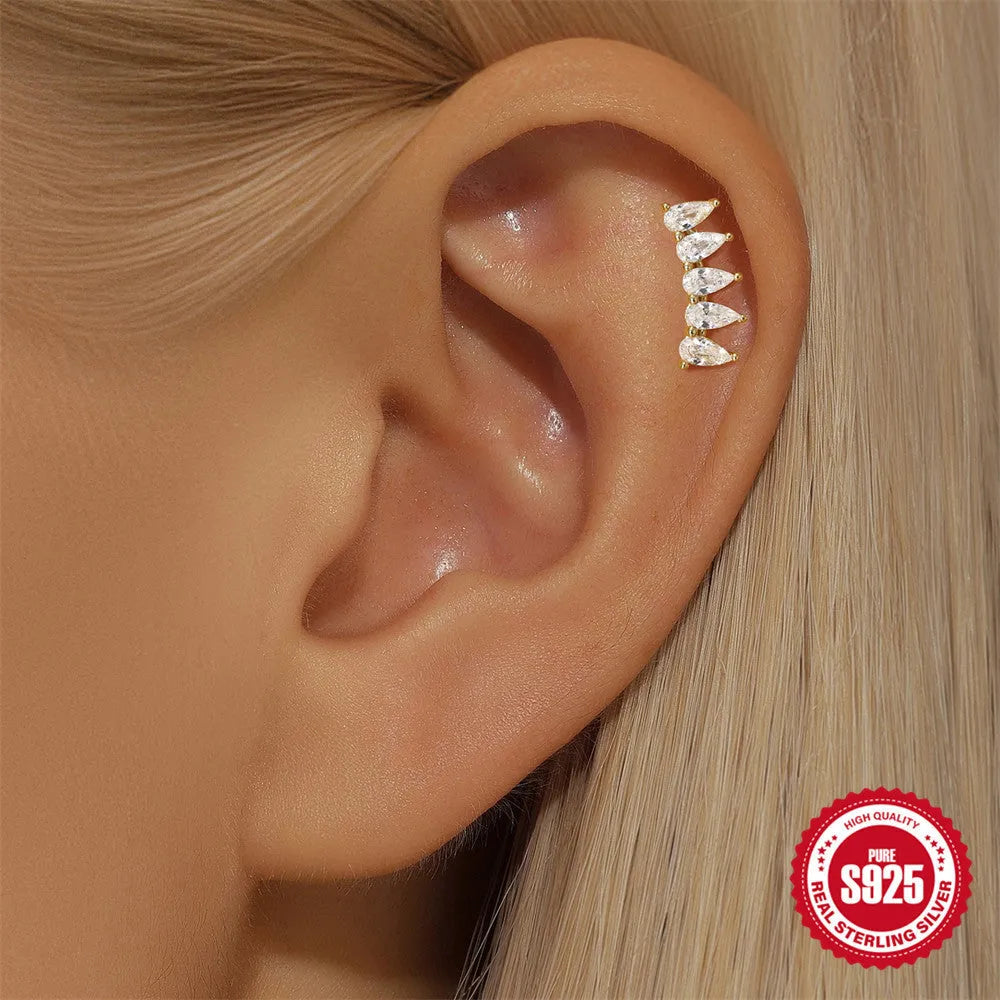 S925 sterling silver moon and star earrings with diamond accents on a gold-coloured background.