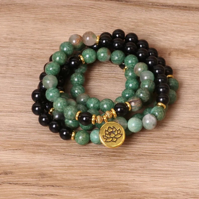 Green and black alloy elastic beaded long bracelet on a wrist, showing natural style design.