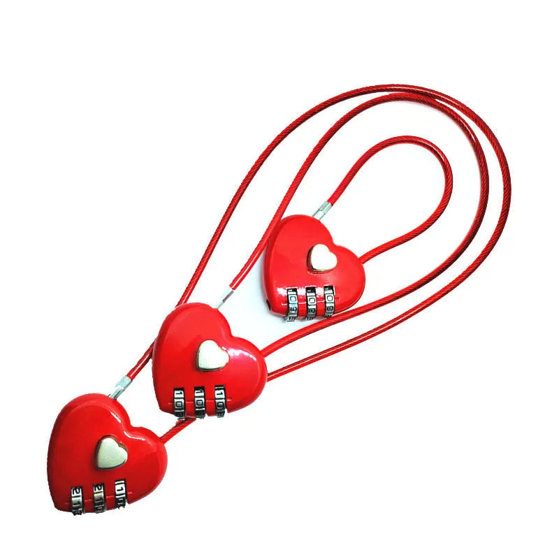 Peach heart shaped combination lock with a long black steel cable, shown in blue plastic.