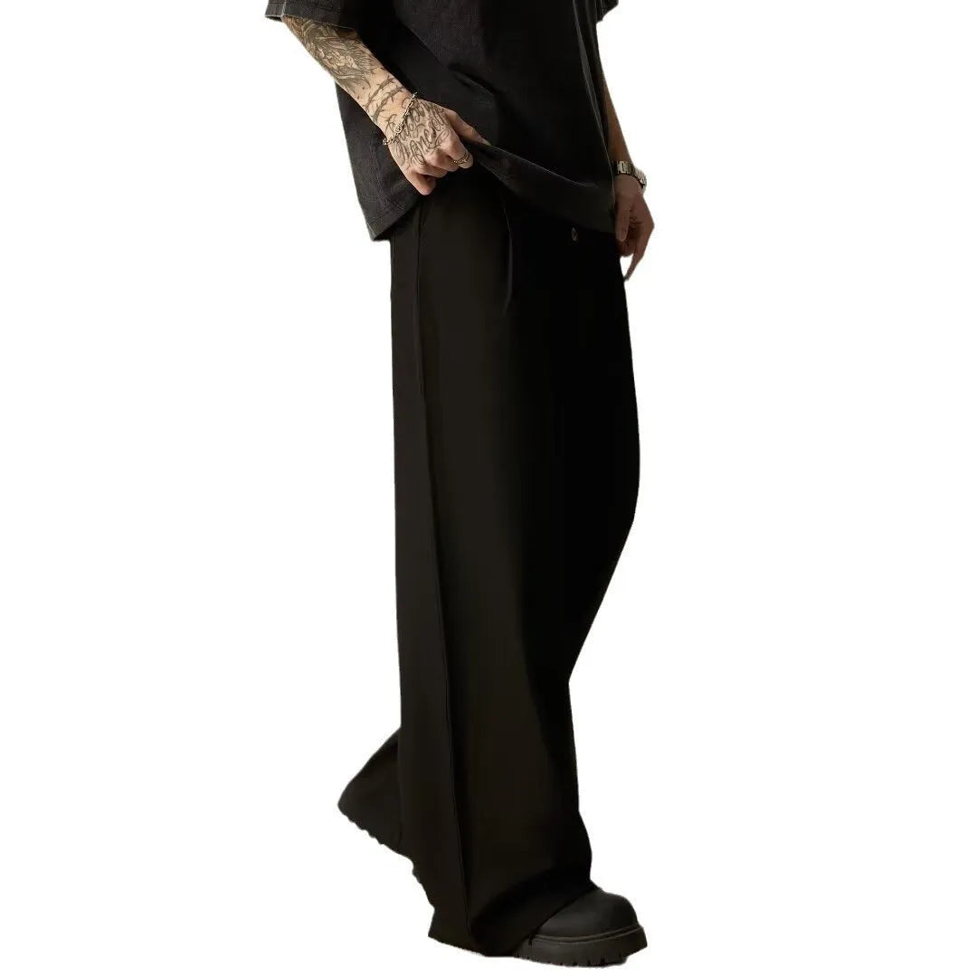Men's black wide-leg casual trousers with vertical stripes and an elastic waistband.
