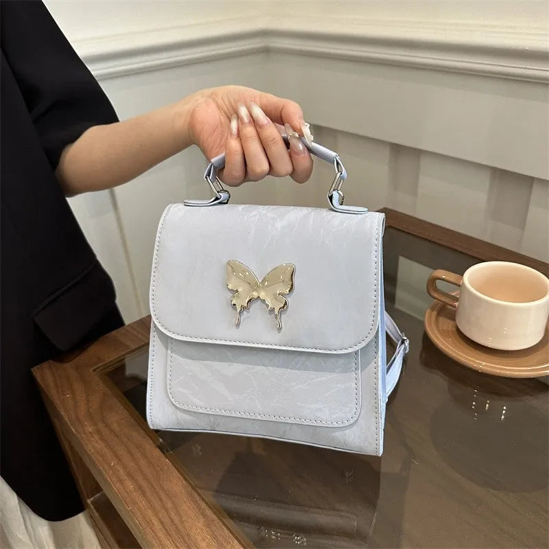 Women's preppy style PU backpack handbag with bow detail in light blue colour