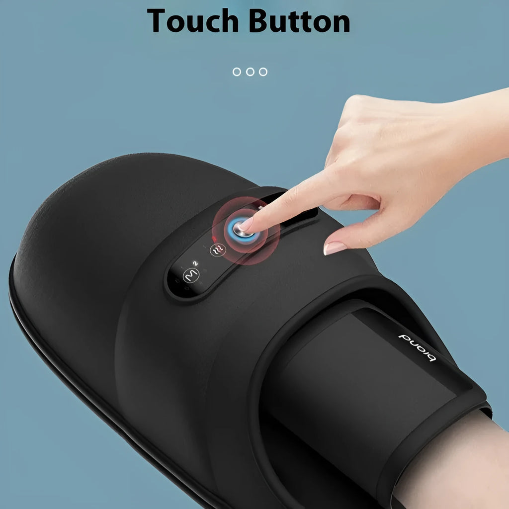 Intelligent electric hand massager with hot compress in black colour, multi-point massage pads, and USB charging cable on a desk
